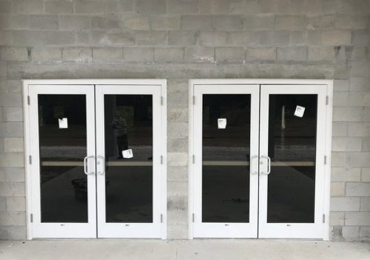 Commercial aluminum entry doors with glass panels