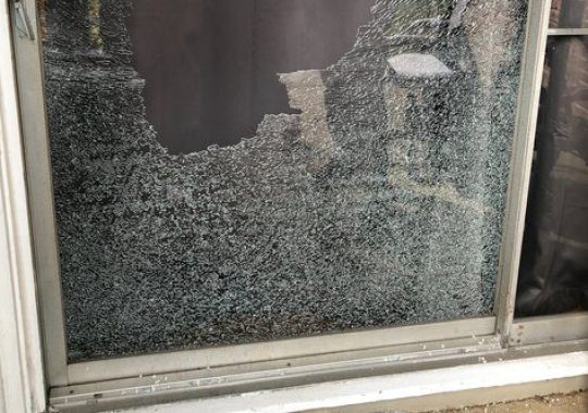 Technician repairing broken window glass